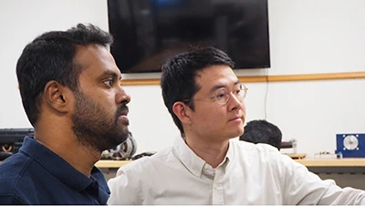 Woongkul “Matt” Lee (right) works with graduate student Avinash Dornala in Lee’s lab, which is developing more efficient power electronics that can help boost the range of electric vehicles. Credit: Matt Davenport