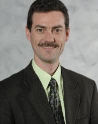 Professional headshot of Tim Hogan