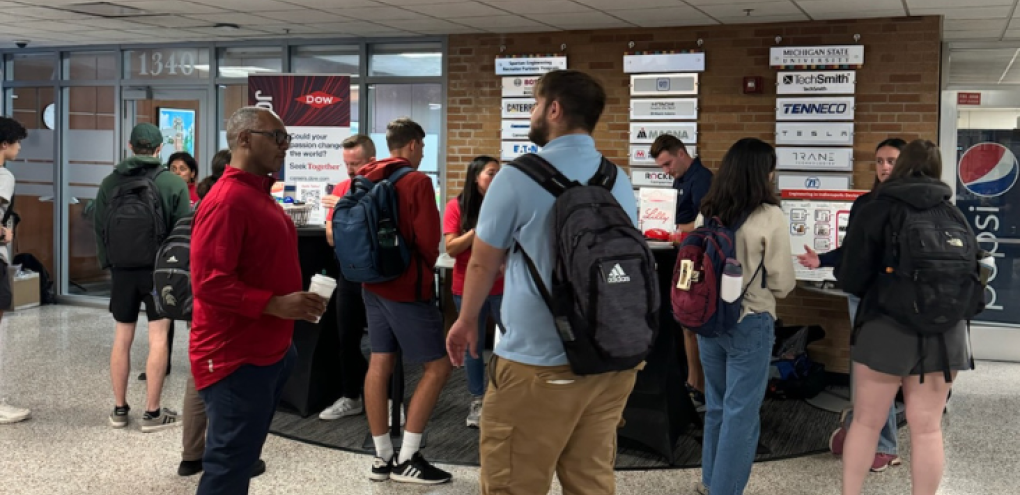 People talking to multiple companies in the lobby of the engineering building