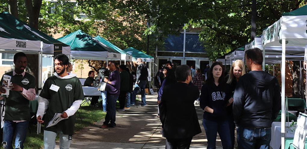 Tents set-up in the Engineering Courtyard with students interacting with people