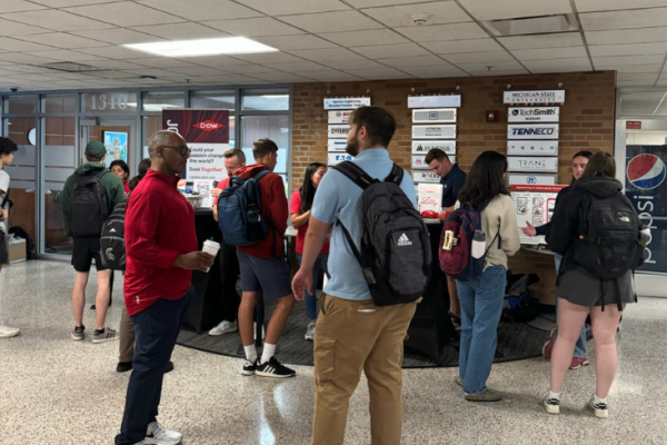People talking to multiple companies in the lobby of the engineering building