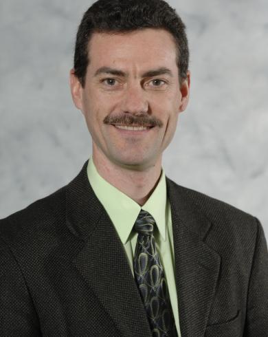 Professional headshot of Tim Hogan